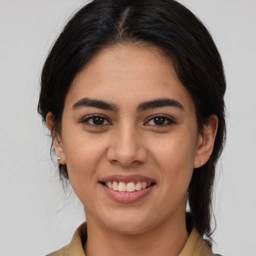 Joyful latino young-adult female with medium  brown hair and brown eyes