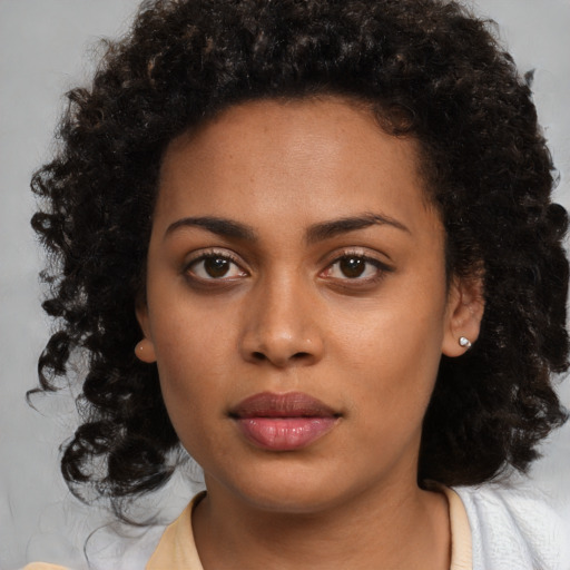 Neutral black young-adult female with medium  brown hair and brown eyes