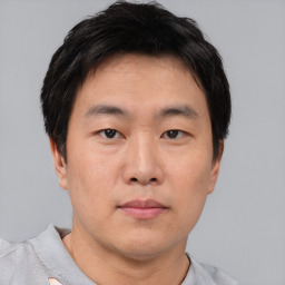 Neutral asian young-adult male with short  brown hair and brown eyes