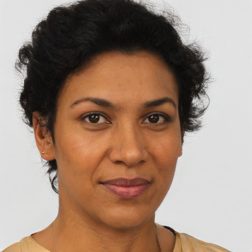 Joyful latino adult female with short  brown hair and brown eyes