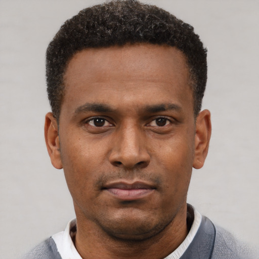 Neutral black young-adult male with short  black hair and brown eyes