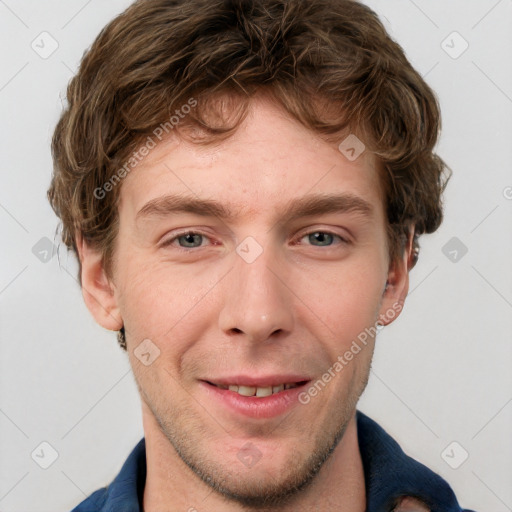 Joyful white young-adult male with short  brown hair and blue eyes