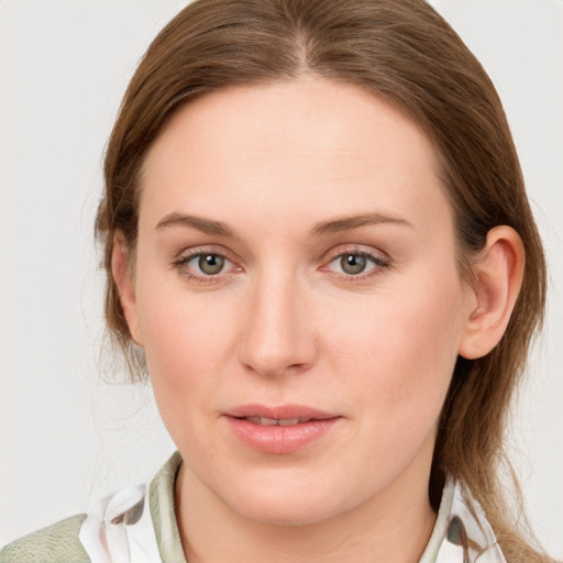 Joyful white young-adult female with medium  brown hair and blue eyes