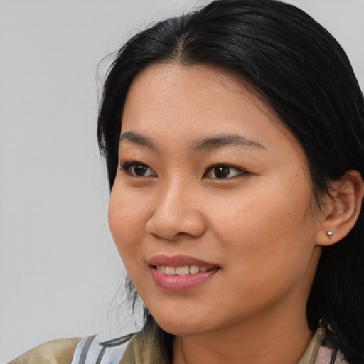 Joyful asian young-adult female with medium  black hair and brown eyes