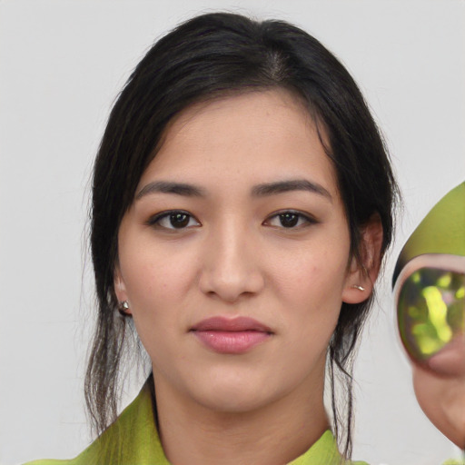 Joyful white young-adult female with medium  black hair and brown eyes