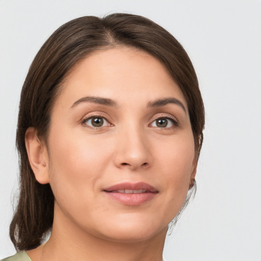 Joyful white young-adult female with medium  brown hair and brown eyes