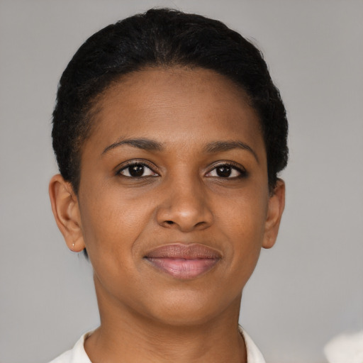 Joyful black young-adult female with short  brown hair and brown eyes