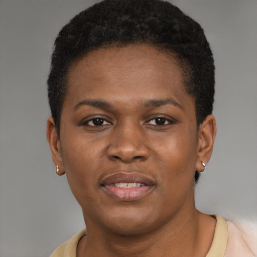 Joyful black young-adult female with short  black hair and brown eyes