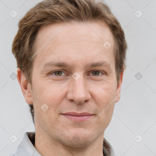 Joyful white adult male with short  brown hair and grey eyes