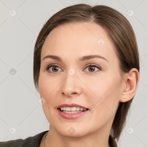 Joyful white young-adult female with medium  brown hair and grey eyes