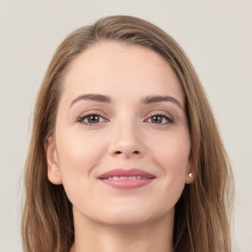 Joyful white young-adult female with long  brown hair and grey eyes