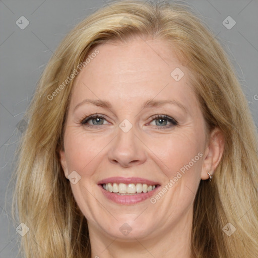 Joyful white adult female with long  brown hair and brown eyes