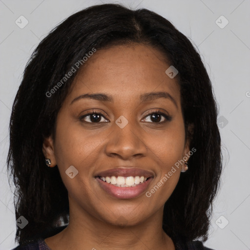 Joyful black young-adult female with long  brown hair and brown eyes