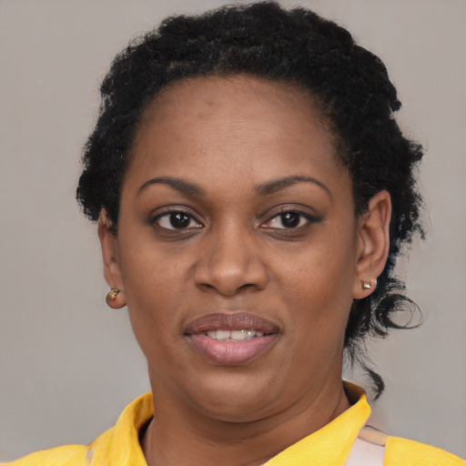 Joyful black young-adult female with short  black hair and brown eyes