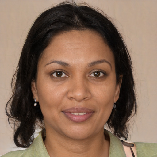 Joyful black adult female with medium  brown hair and brown eyes