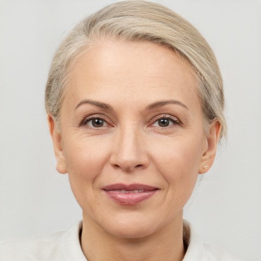 Joyful white adult female with medium  brown hair and brown eyes