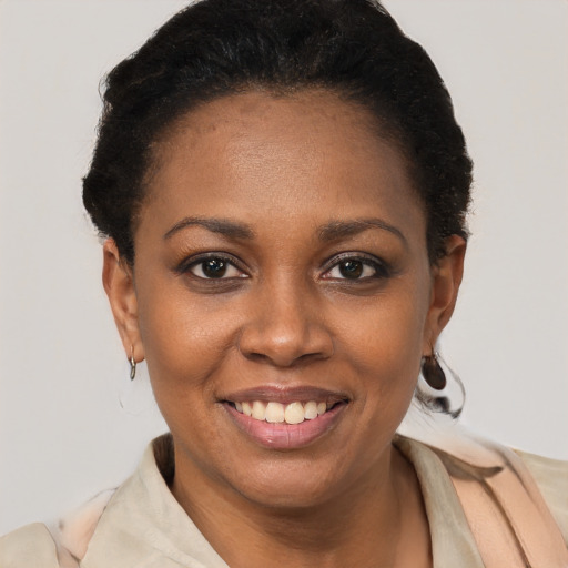 Joyful black young-adult female with short  black hair and brown eyes