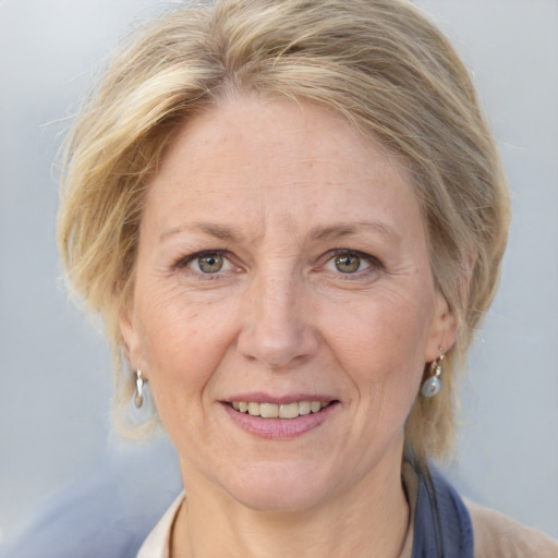 Joyful white adult female with medium  brown hair and blue eyes