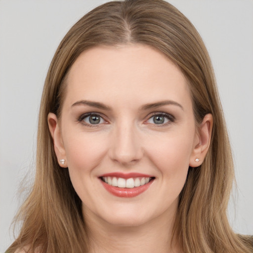 Joyful white young-adult female with long  brown hair and brown eyes