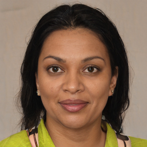 Joyful black adult female with medium  brown hair and brown eyes