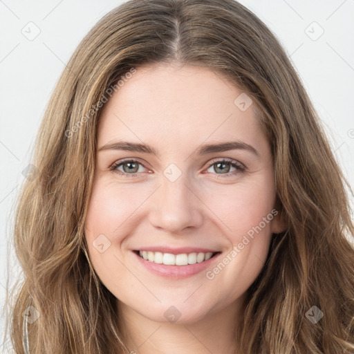 Joyful white young-adult female with long  brown hair and green eyes