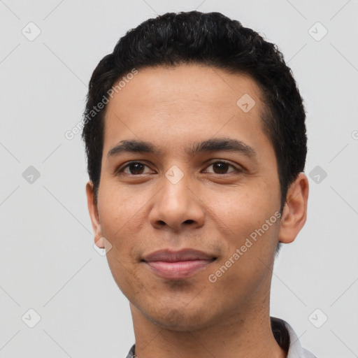 Joyful latino young-adult male with short  black hair and brown eyes