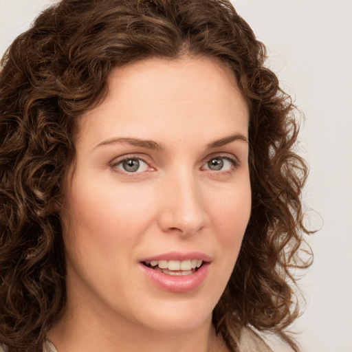 Joyful white young-adult female with long  brown hair and green eyes