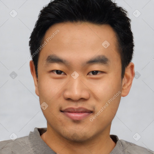 Joyful asian young-adult male with short  black hair and brown eyes