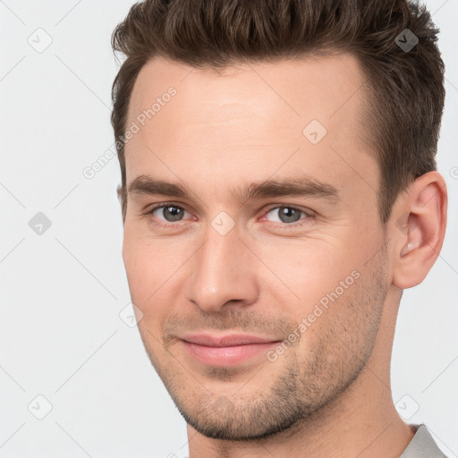 Joyful white young-adult male with short  brown hair and brown eyes