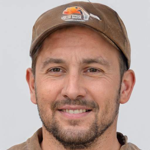 Joyful white adult male with short  brown hair and brown eyes