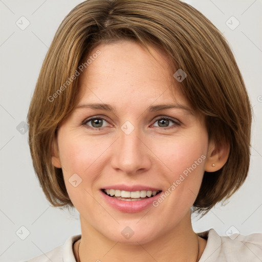 Joyful white adult female with medium  brown hair and grey eyes