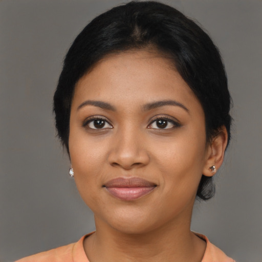 Joyful black young-adult female with medium  black hair and brown eyes