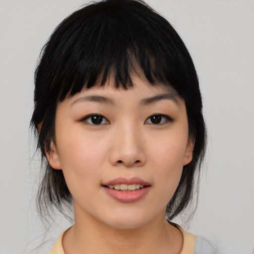 Joyful asian young-adult female with medium  black hair and brown eyes