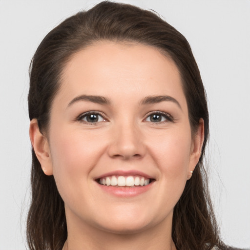 Joyful white young-adult female with long  brown hair and grey eyes