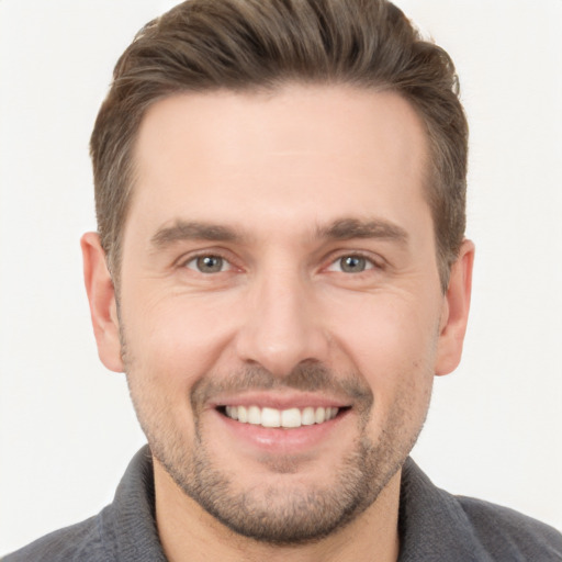 Joyful white young-adult male with short  brown hair and brown eyes