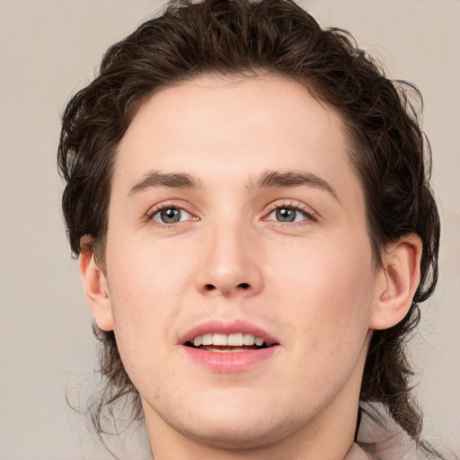 Joyful white young-adult male with medium  brown hair and brown eyes