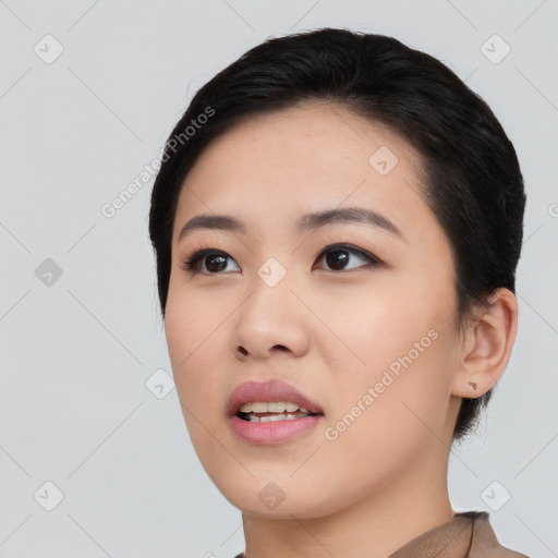 Joyful asian young-adult female with short  black hair and brown eyes