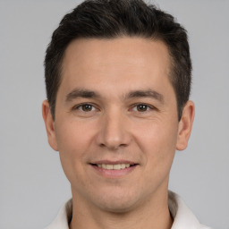 Joyful white young-adult male with short  brown hair and brown eyes