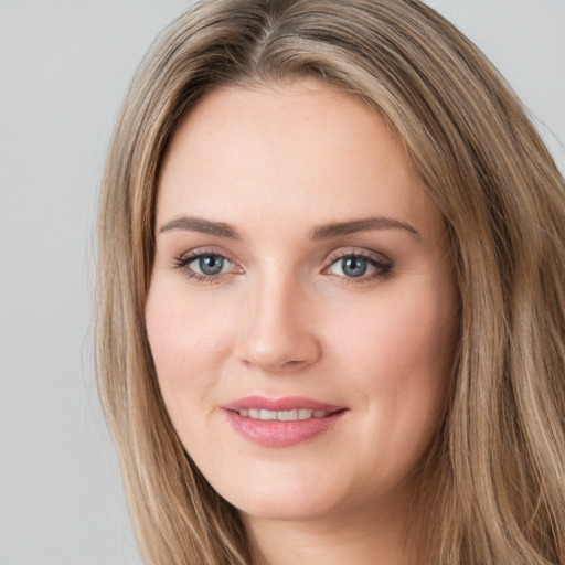 Joyful white young-adult female with long  brown hair and green eyes