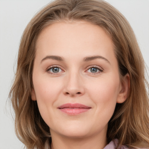 Joyful white young-adult female with long  brown hair and grey eyes