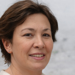 Joyful white adult female with short  brown hair and brown eyes