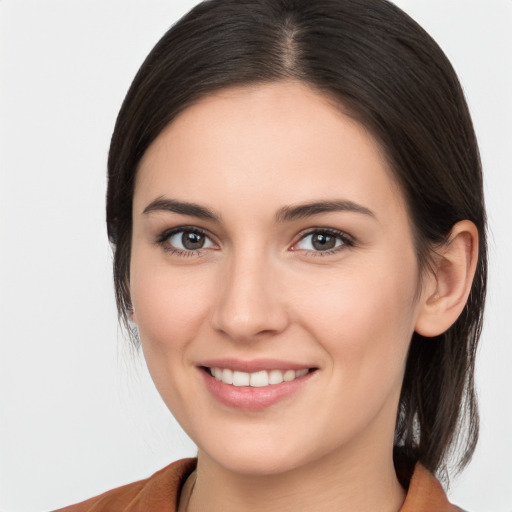 Joyful white young-adult female with medium  brown hair and brown eyes