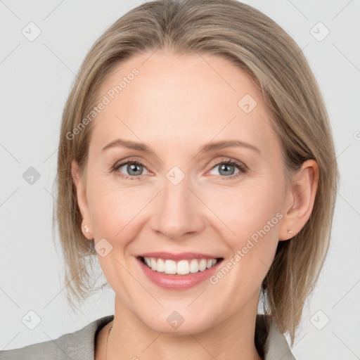 Joyful white adult female with medium  brown hair and grey eyes