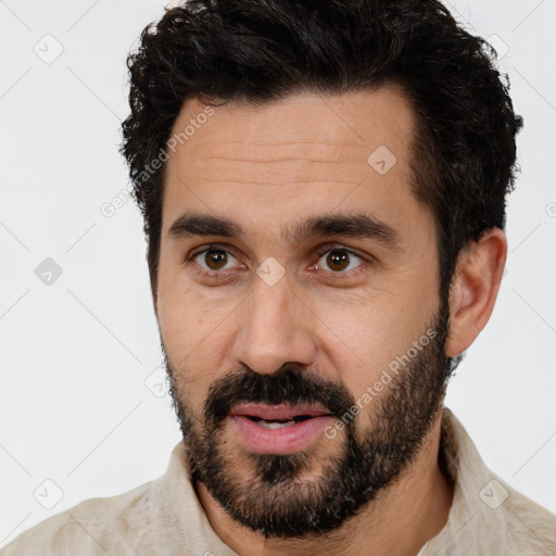 Joyful white young-adult male with short  black hair and brown eyes