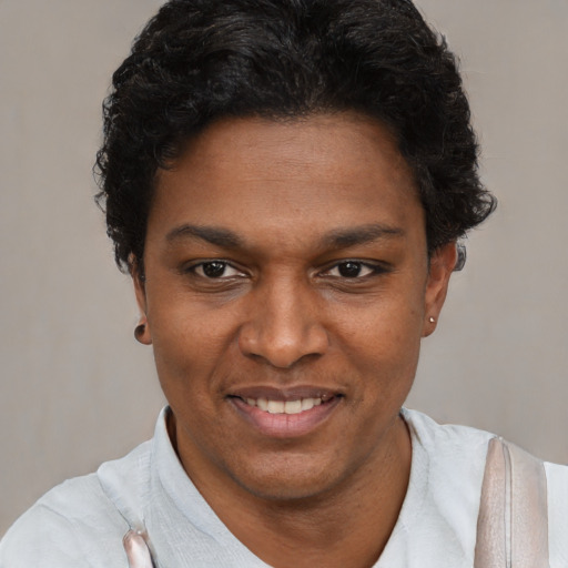 Joyful black young-adult female with short  black hair and brown eyes