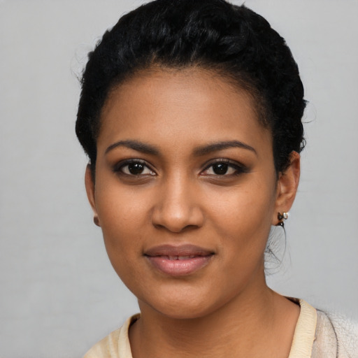 Joyful black young-adult female with short  black hair and brown eyes