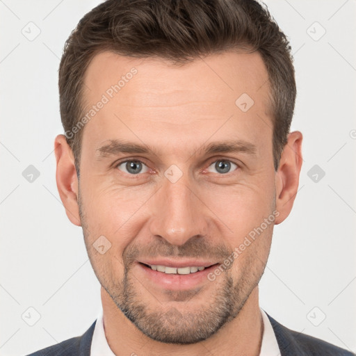 Joyful white adult male with short  brown hair and brown eyes