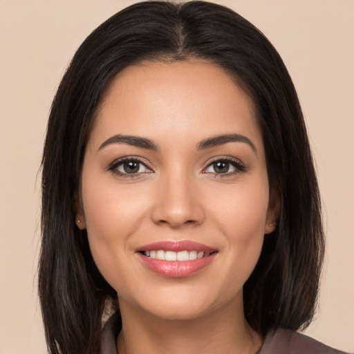 Joyful white young-adult female with long  brown hair and brown eyes