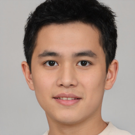 Joyful asian young-adult male with short  brown hair and brown eyes