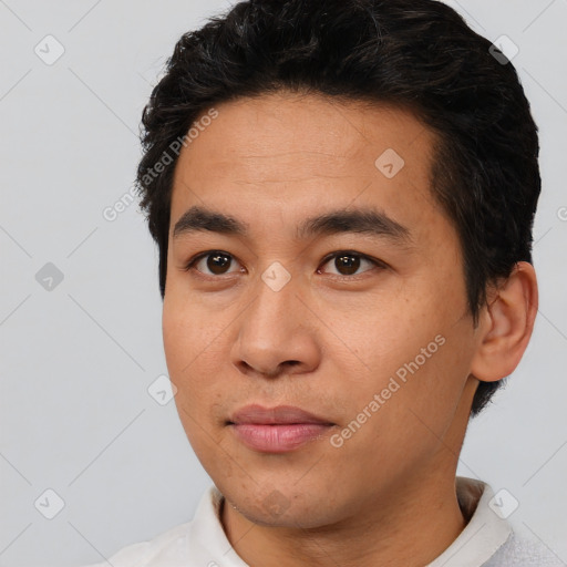 Joyful asian young-adult male with short  black hair and brown eyes